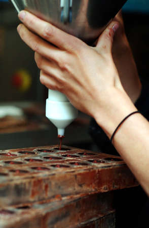 molten chocolate being pour into a mouldの写真素材