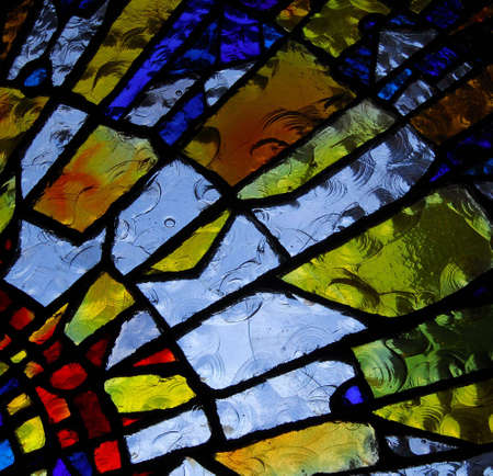 stainglass of an old church showing pattern and colorsの写真素材