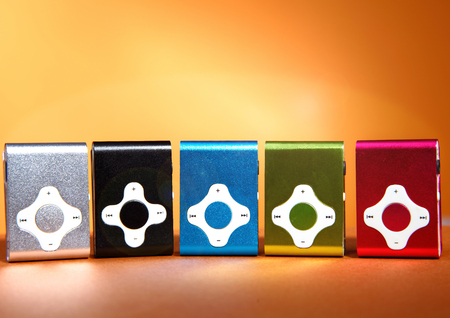 device mp3 player on orange table shadow reflection set manyの写真素材