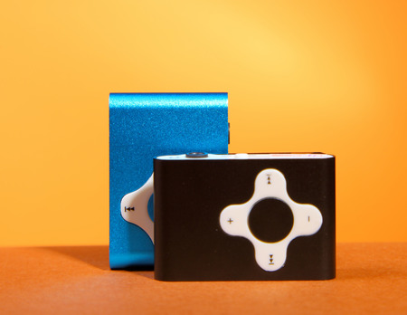 device mp3 player on orange table shadow reflection setの写真素材