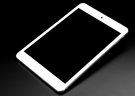 Tablet black silver metal on black background with shadow cutout isolated without screen sideの写真素材