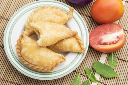 Thai curry puff with vegetables on table
