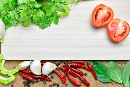 Tomato and Organic vegetables on a wooden backgroundの写真素材