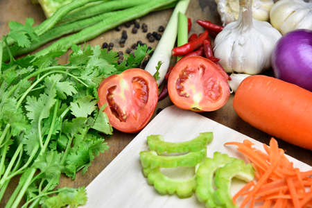 Tomato and Organic vegetables on a wooden backgroundの写真素材