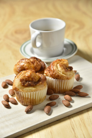 Almond Danish Cupcakes with coffee on wooden backgroundの写真素材