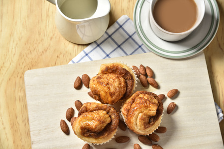 Almond Danish Cupcakes with coffee on wooden backgroundの写真素材
