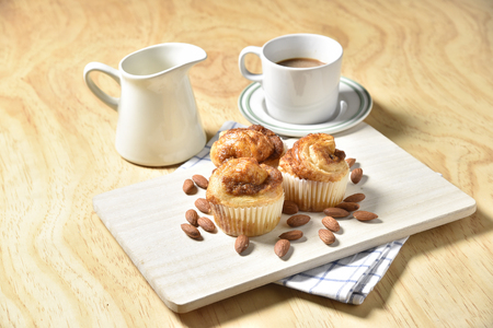 Almond Danish Cupcakes with coffee on wooden backgroundの写真素材