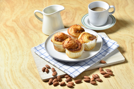 Almond Danish Cupcakes with coffee on wooden backgroundの写真素材