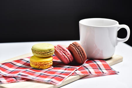 Macaron with coffee cup on black background.の写真素材