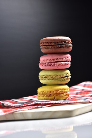 Macaron with coffee cup on black background.の写真素材