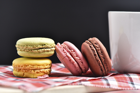 Macaron with coffee cup on black background.の写真素材