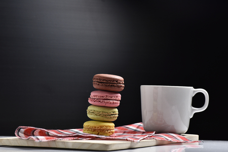 Macaron with coffee cup on black background.の写真素材