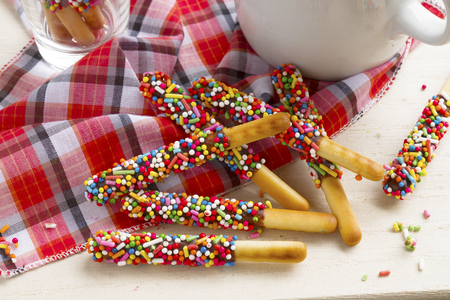 Pepero candy with hot coffee on wooden background.の写真素材