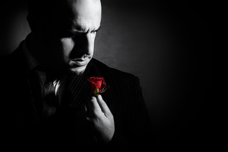 Portrait of man, godfather-like character. Black and white studio shot.の写真素材