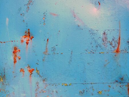 Abstract photography of a blue, rusty and dented container wall.の写真素材