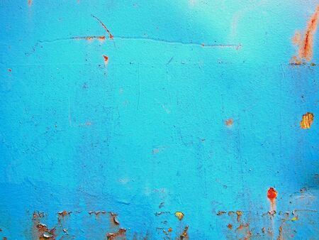 Abstract photography of a blue, rusty and dented container wall.の写真素材