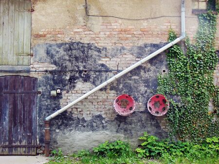 Minimal photography of a weathered, abandoned and neglected house wall.の写真素材