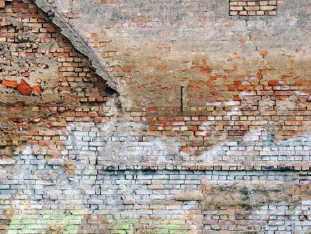 Minimal photography of a weathered, abandoned and neglected house wall.の写真素材