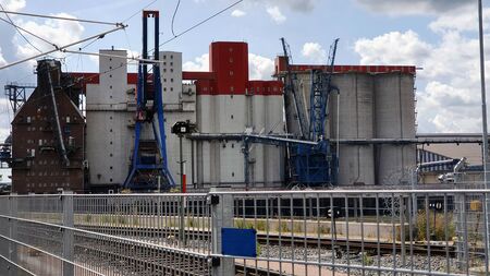 Photographer on an industrial landscape with industrial buildingsの写真素材