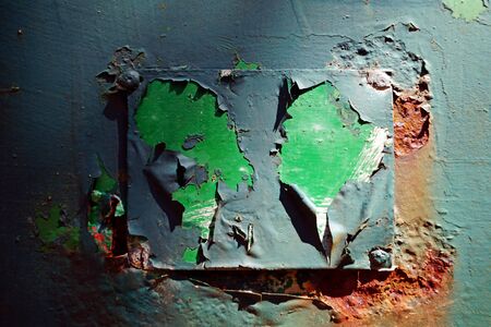 Abstract cluse on a weathered, abandoned, and neglected metal wallの写真素材