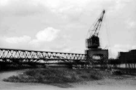 Blurred black and white analogue exposure of an industrial landscape.の写真素材