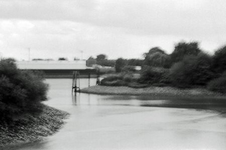Blurred black and white analogue exposure of an industrial landscape.の写真素材