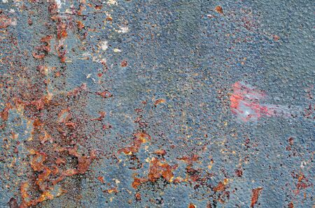 Close up and abstract view of a rusty, weathered and neglected metal plateの写真素材