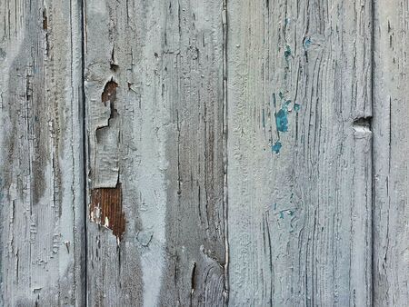 Close up photography of a gray wooden garage door with peeling paintの写真素材