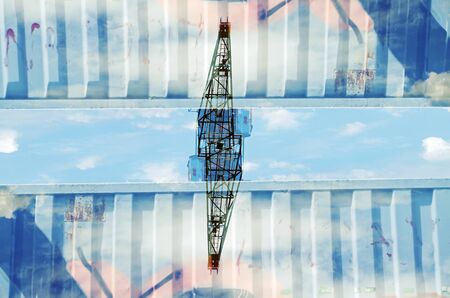 Abstract mirrored digital double exposure of a crane in an industrial landscape.の写真素材