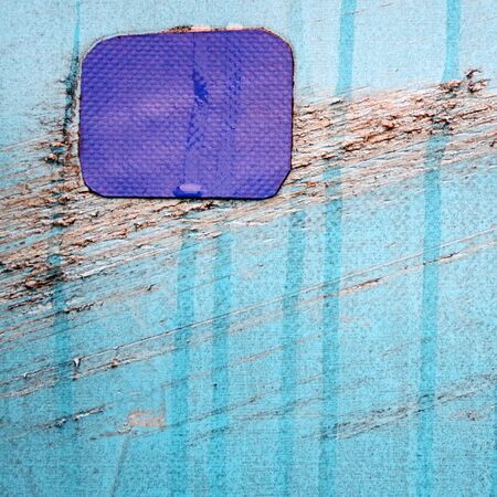 Close up photography of a weathered wodden wall with peeling paint..の写真素材