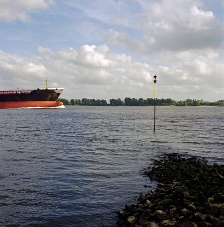 Color analog photography of a nautical vessel, passing by on a riverの写真素材