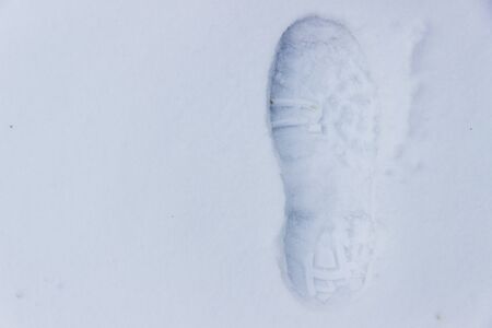 A single footprint on the white snowの写真素材
