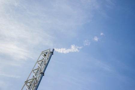 Boiler room chimney with steam and blue sky on backgroundの写真素材