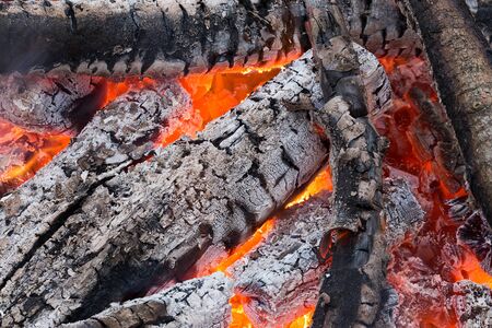 Blazing red coals in the fire, burning wood