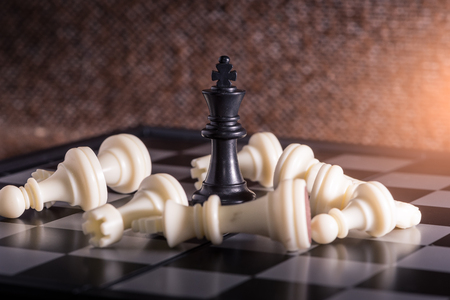 the abstract image of the staunton chess set which has the king placed on chess board and the another in chess set placed around. the comcept of strategy, victory, business, win, games, intelligence.の写真素材