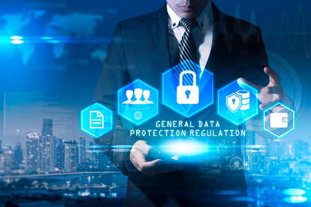 The abstract image of the business man hold the GDPR hologram on hand and overlay with cityscape image. the concept of data, communications, privacy, internet of things and GDPR.の写真素材