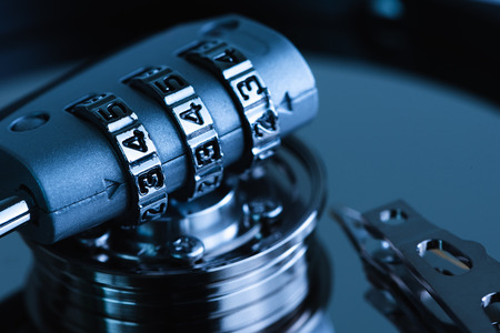 The abstract image of the padlock located on the top of hard disk. the concept of data, hardware,...