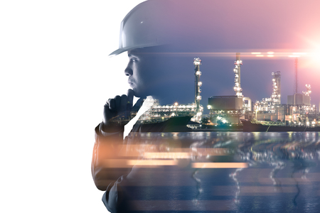 the double exposure image of the engineer thinking overlay with oil refinery image.The concept of energy, engineering, construction and industrial.の写真素材