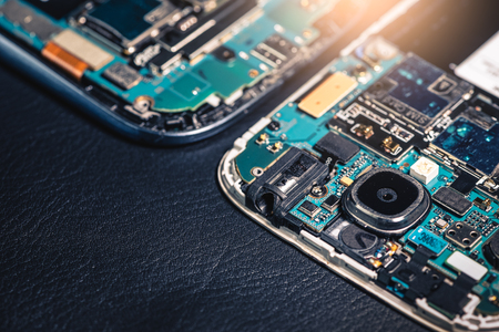 The inside of the twin smartphone's motherboard lay on the back table and copy space. the concept of...