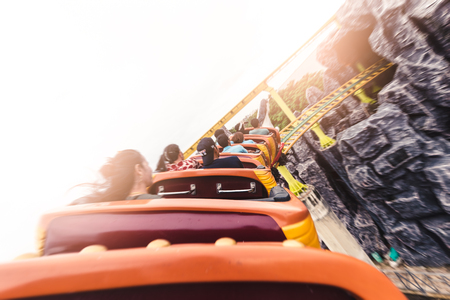 the abstract image of the roller coaster running on the rail in amusement park. the concept of extreme, fun, holiday and vacation.の写真素材