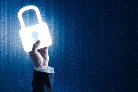 The abstract image of the businessman hold the padlock hologram on hand. The concept of cyber security, online, gdpr, information technology and internet of things.の写真素材