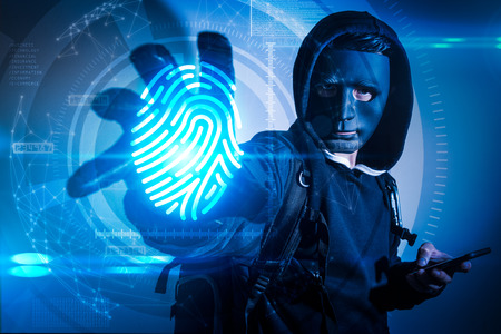The abstract image of the hacker using a smartphone computer and reach hand for stealing the...