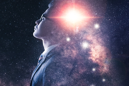 The double exposure image of the businessman thinking overlay with milky way galaxy image. the concept of imagination, technology, future and inspiration.の写真素材