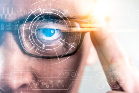 The abstract image of the businessman wear a smart glasses overlay with futuristic hologram. The...