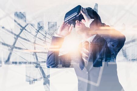 The abstract double exposure image of businessman using a smart glasses or vr glasses overlay with virtual hologram image. the concept of communication, internet of things and future life.の写真素材