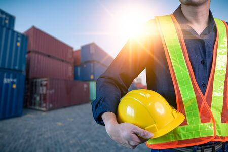 The abstract image of the engineer standing in shipping container yard and copy space. the concept...