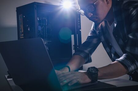 The technician hold the screwdriver for repairing the computer. the concept of computer hardware,...