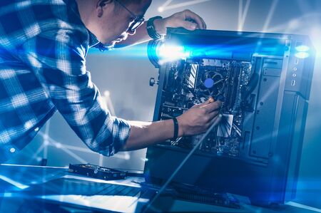 The technician hold the screwdriver for repairing the computer. the concept of computer hardware,...