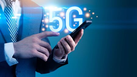 The abstract image of businessman using a smartphone overlay with 5g and cityscape hologram. the concept of 5G, communication, network, connection, internet of things.の写真素材