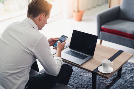 the abstract image of the man is quarantining himself and use video conference method at his home office. the concept of covid-19, work at home, quarantine, healthcare and business.の写真素材